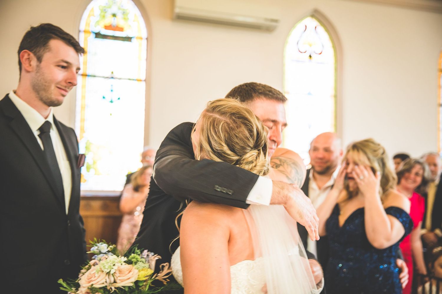 Intimate wedding moments photographed inside a traditional church setting.