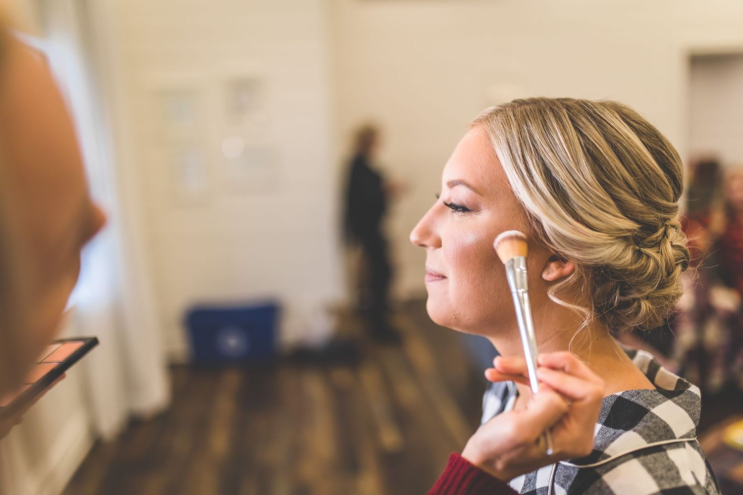 Wedding day preparation with professional styling in a bright indoor space.