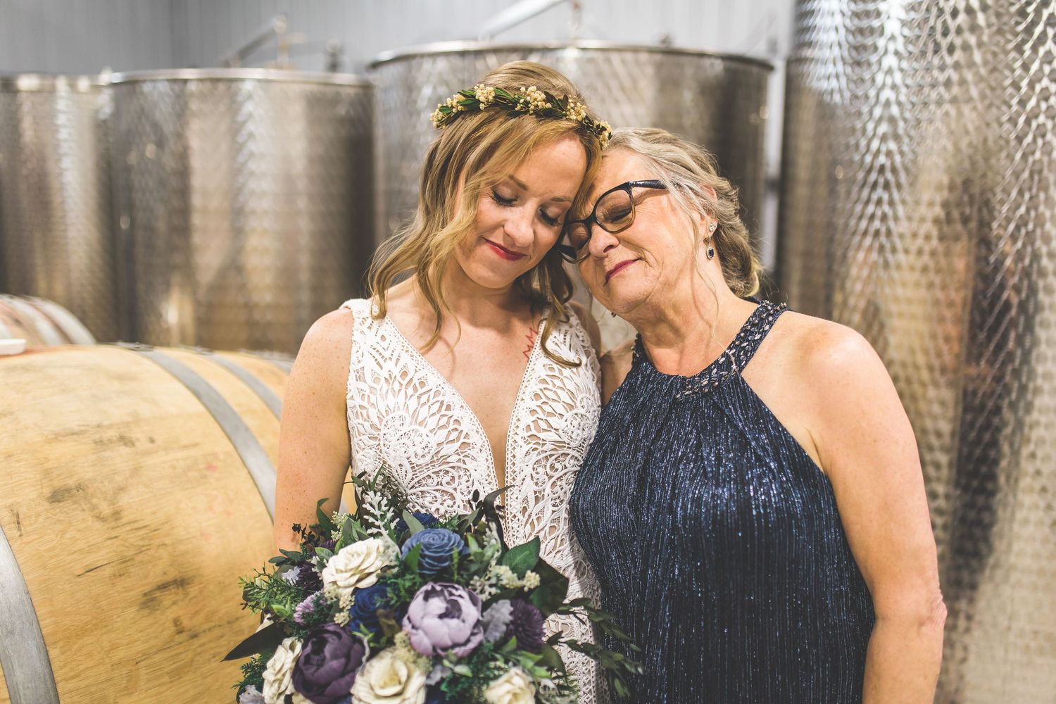 Wedding party members share candid moments in a rustic winery setting.