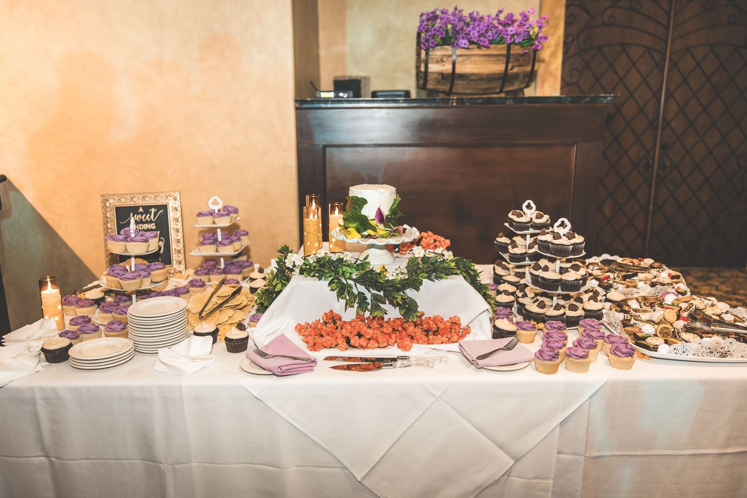 Elegant wedding reception buffet table with desserts and appetizers.