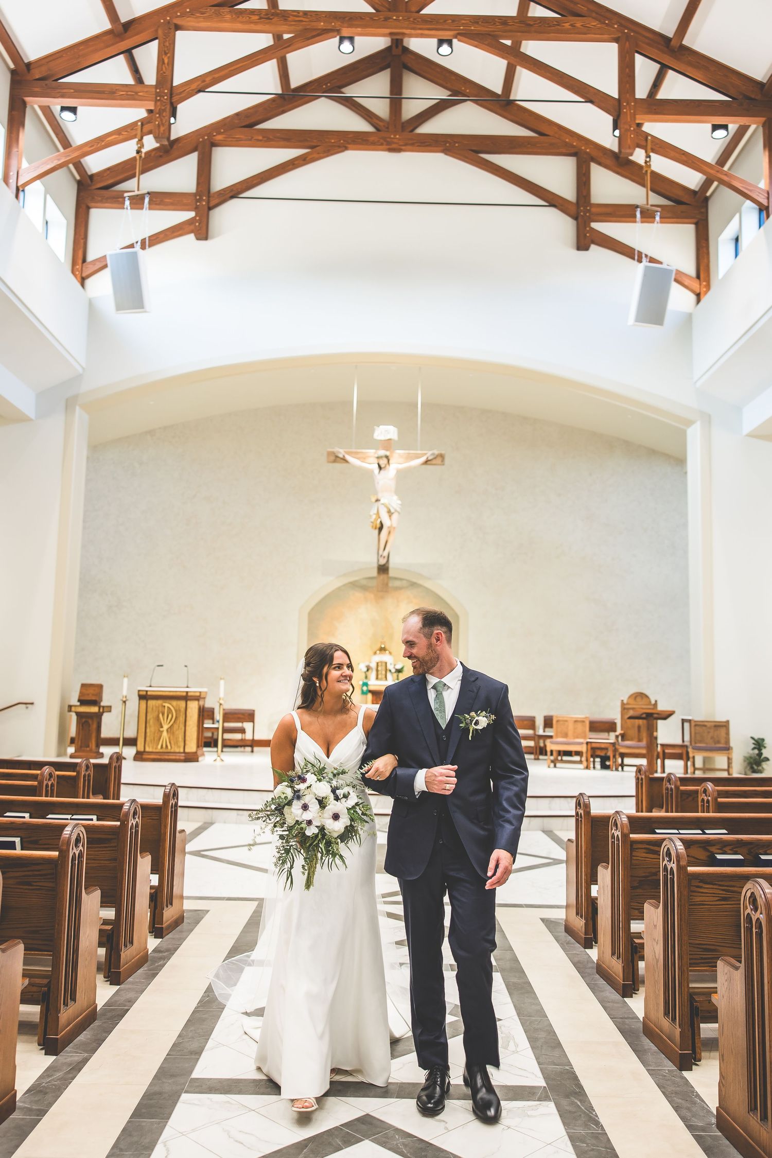 A series of romantic wedding photos showing a couple walking through a church aisle with wooden pews and exposed beams.