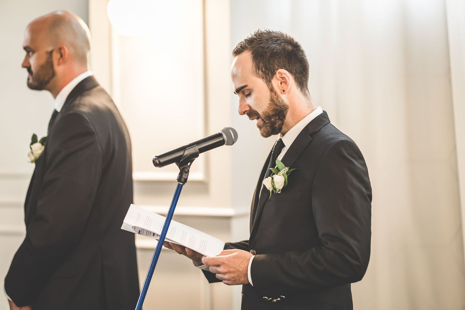 Wedding ceremony participants exchanging vows in front of gathered guests.