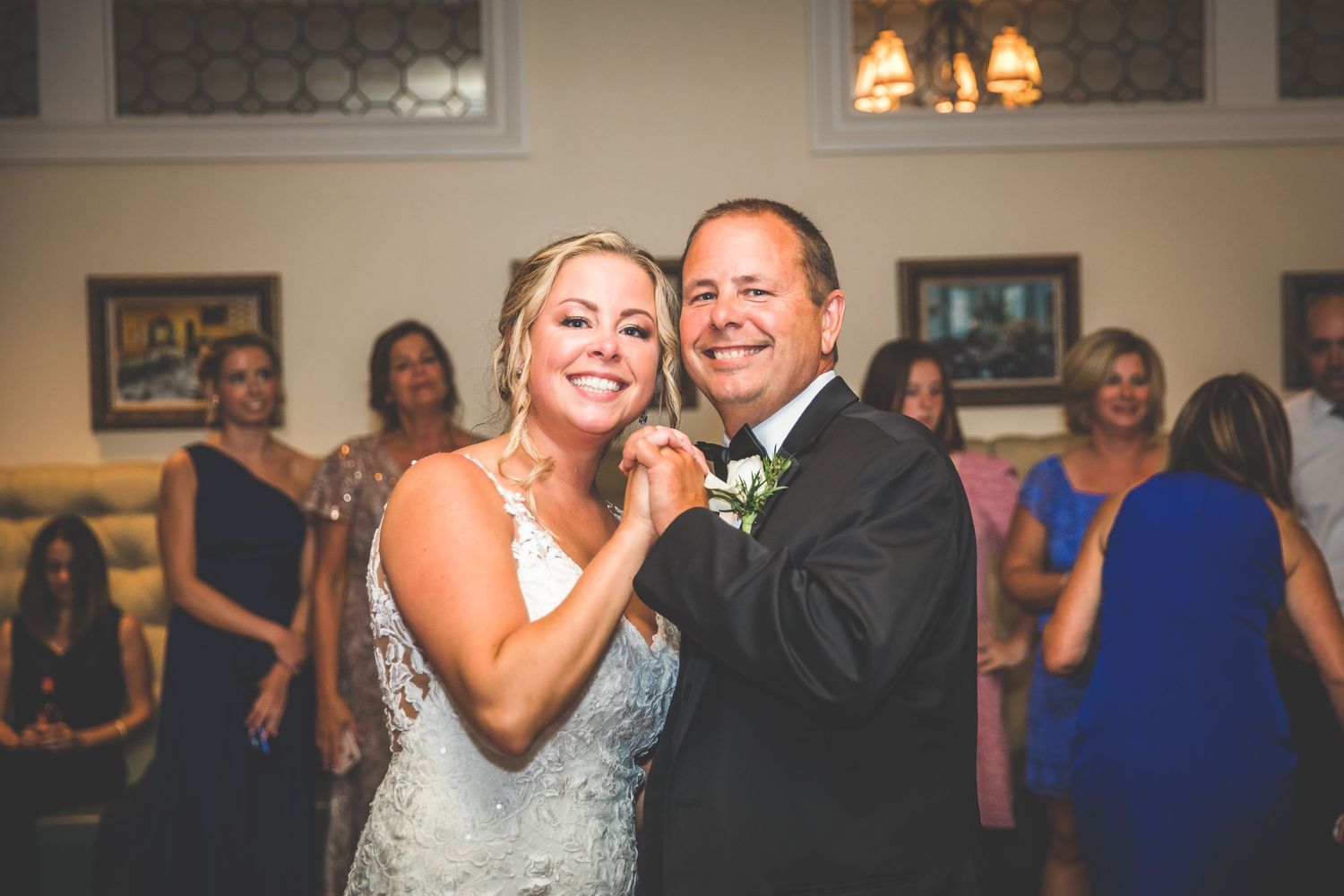 Wedding celebration candids showing emotional moments in a beautifully decorated venue.
