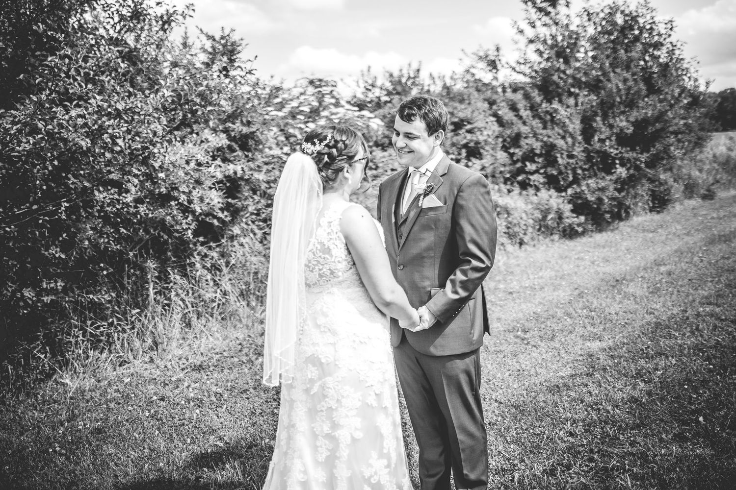 Black and white wedding portraits captured in a natural outdoor setting.