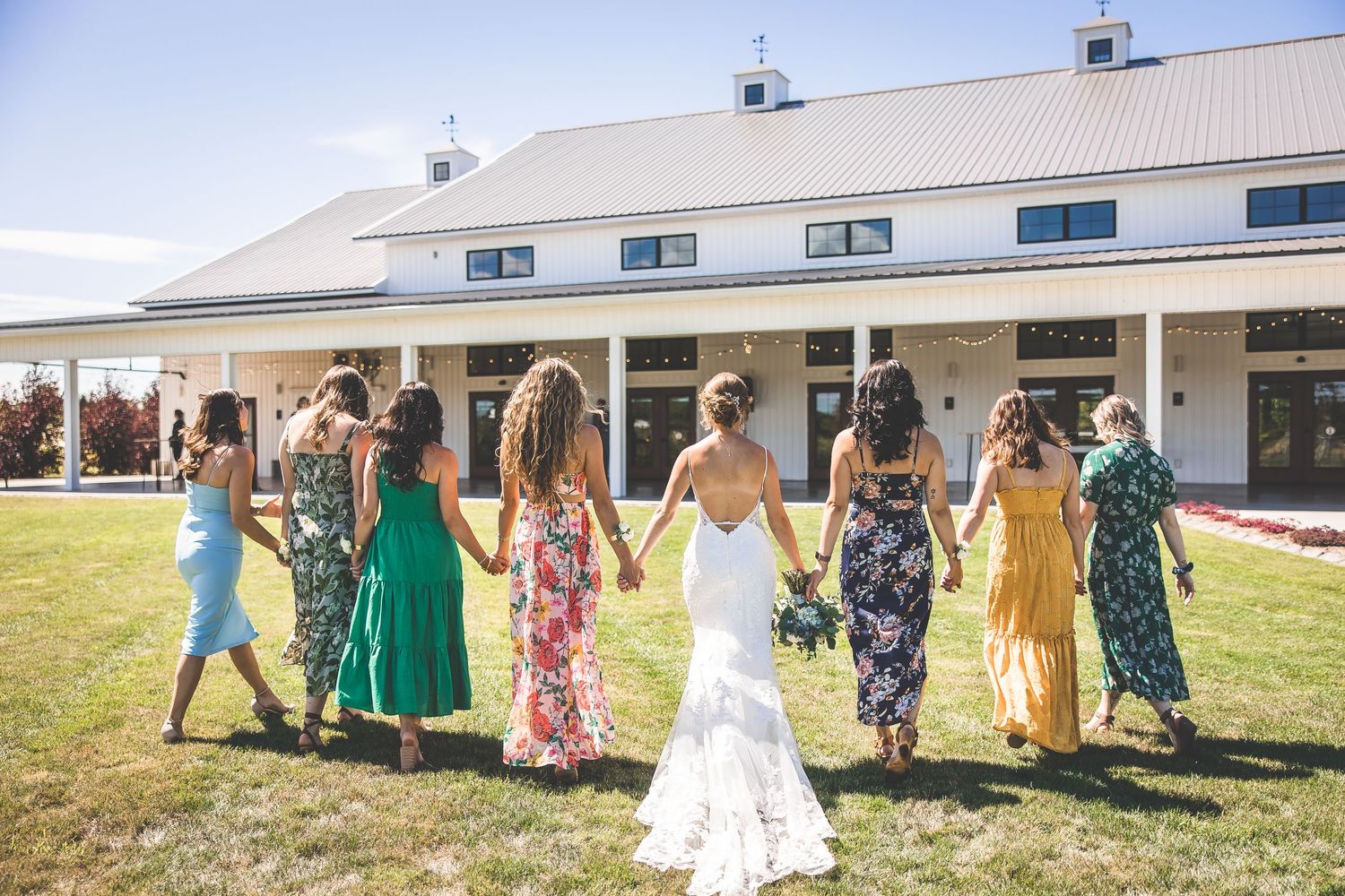 Panoramic view of a wedding venue with white buildings and outdoor gathering spaces.
