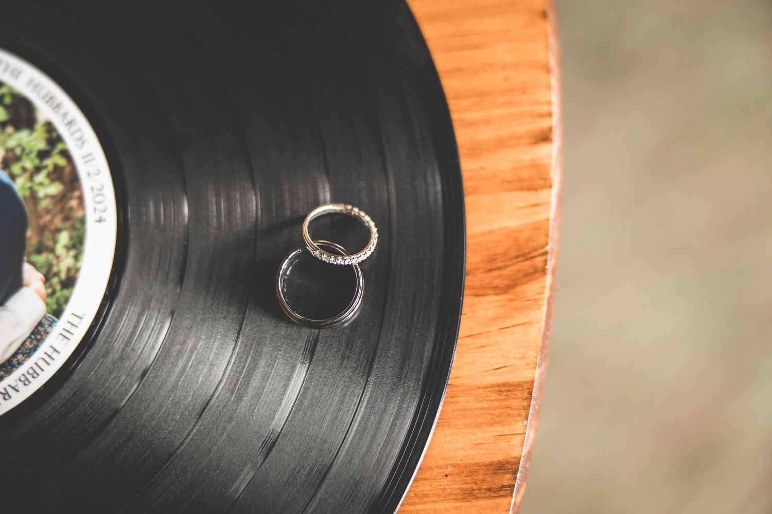 Wedding rings artistically photographed on a vintage vinyl record.