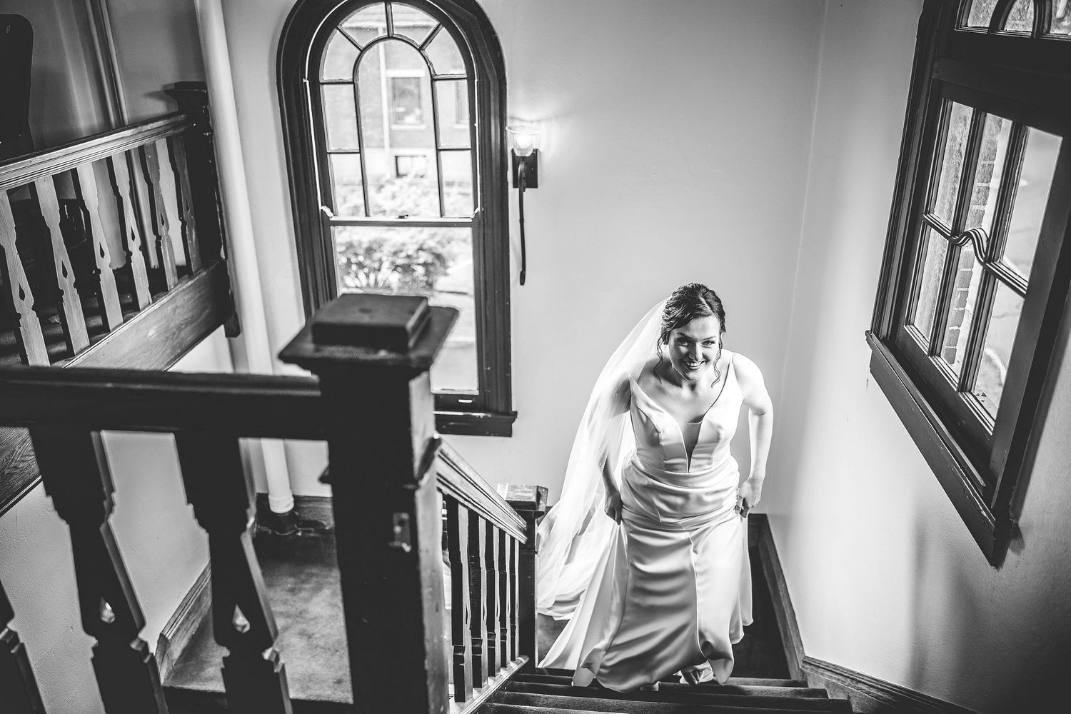 Black and white images showing someone walking up stairs in a historic building.