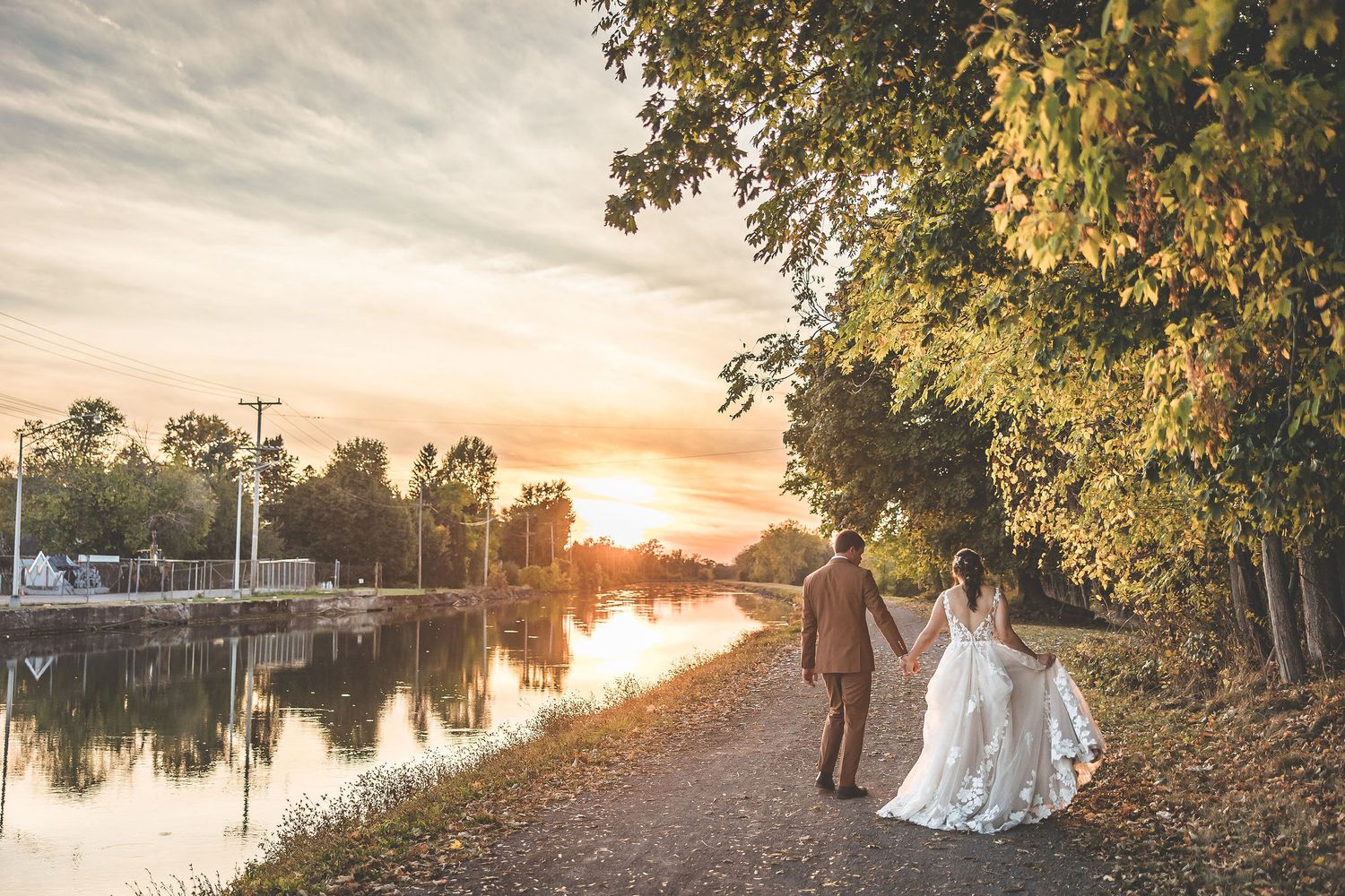 Panoramic wedding photography with sunset water views and natural landscape.