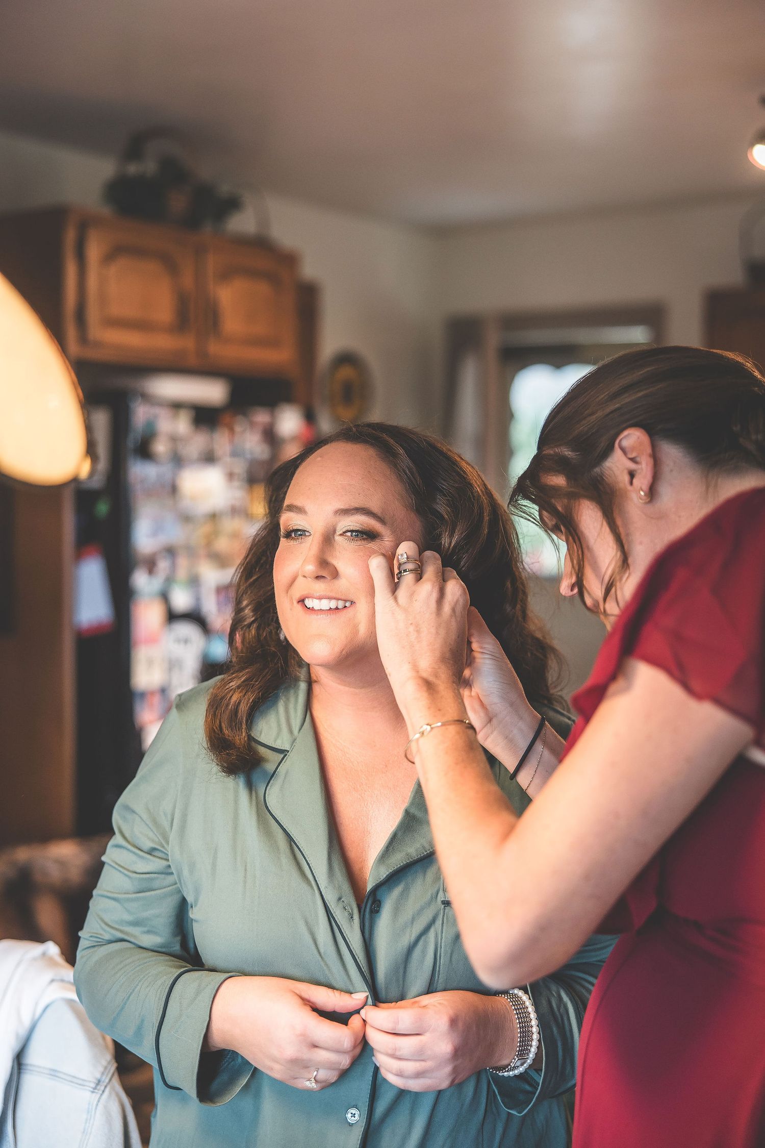 An emotional candid moment shared between people during a wedding preparation.