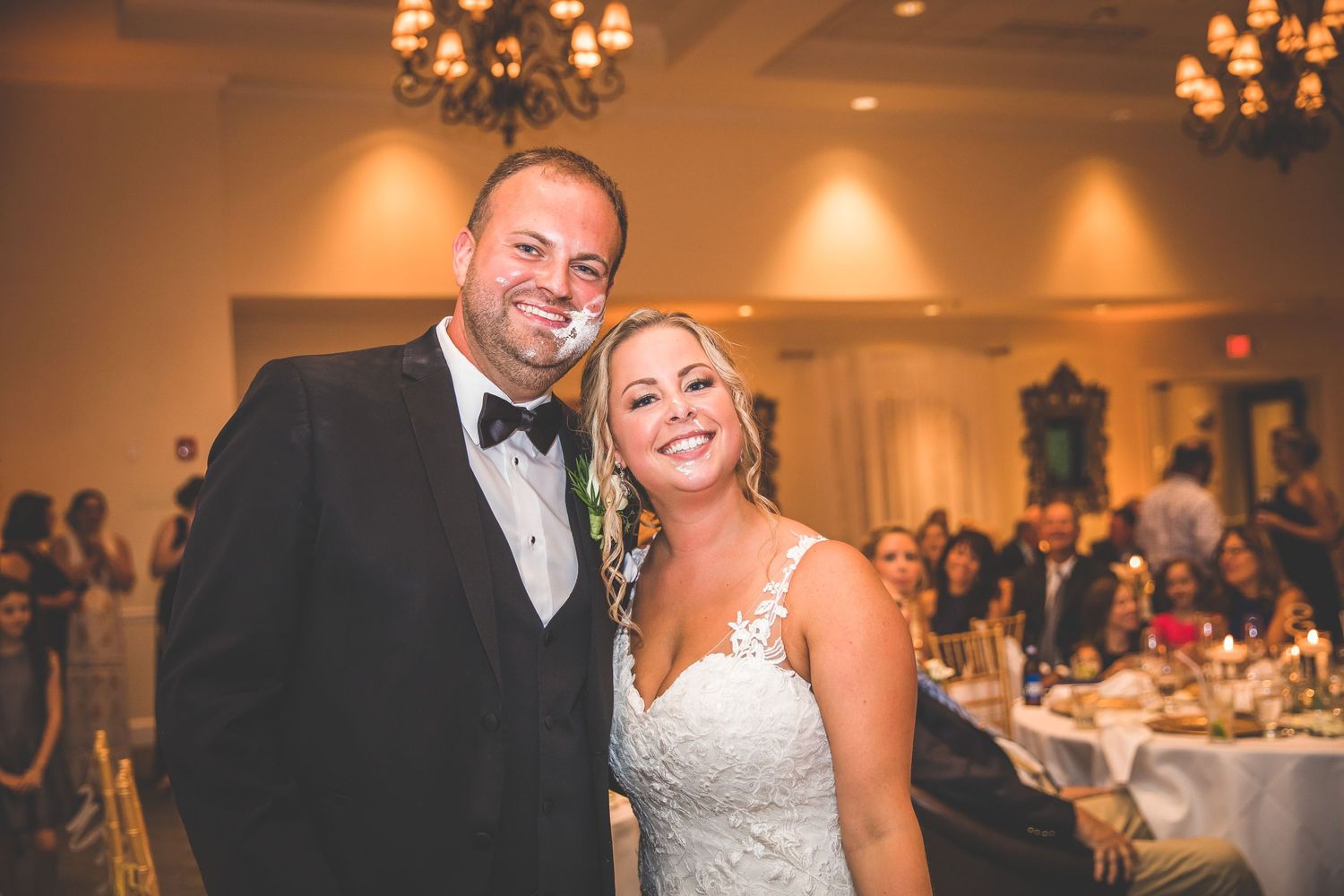 Romantic moments captured during wedding reception festivities in an elegant ballroom.