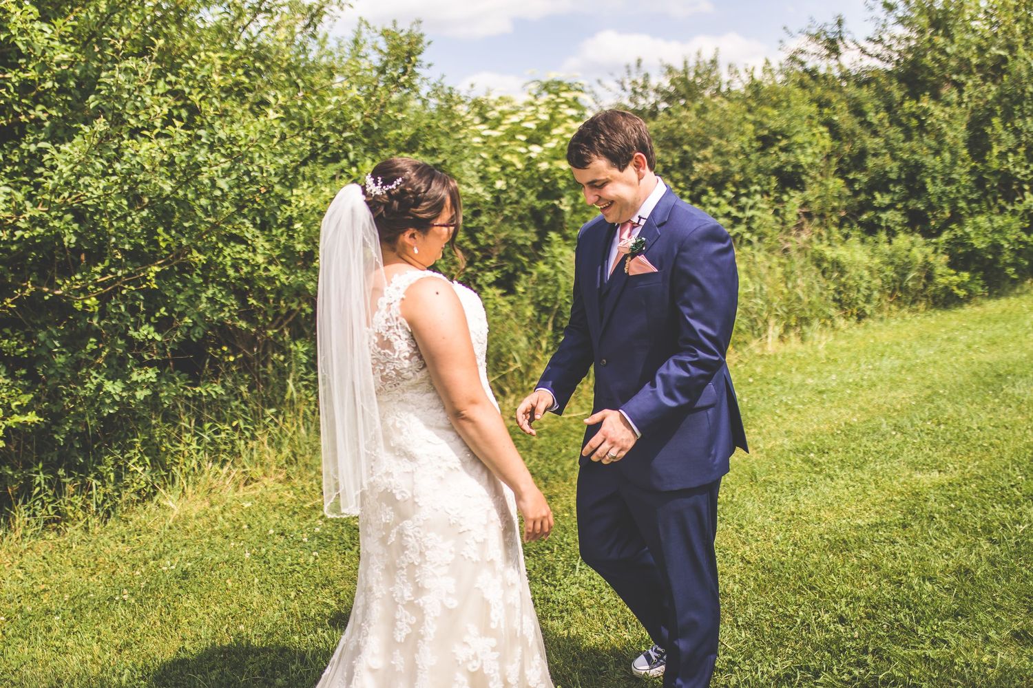 Wedding couple's first look reaction sequence in a sunny garden.