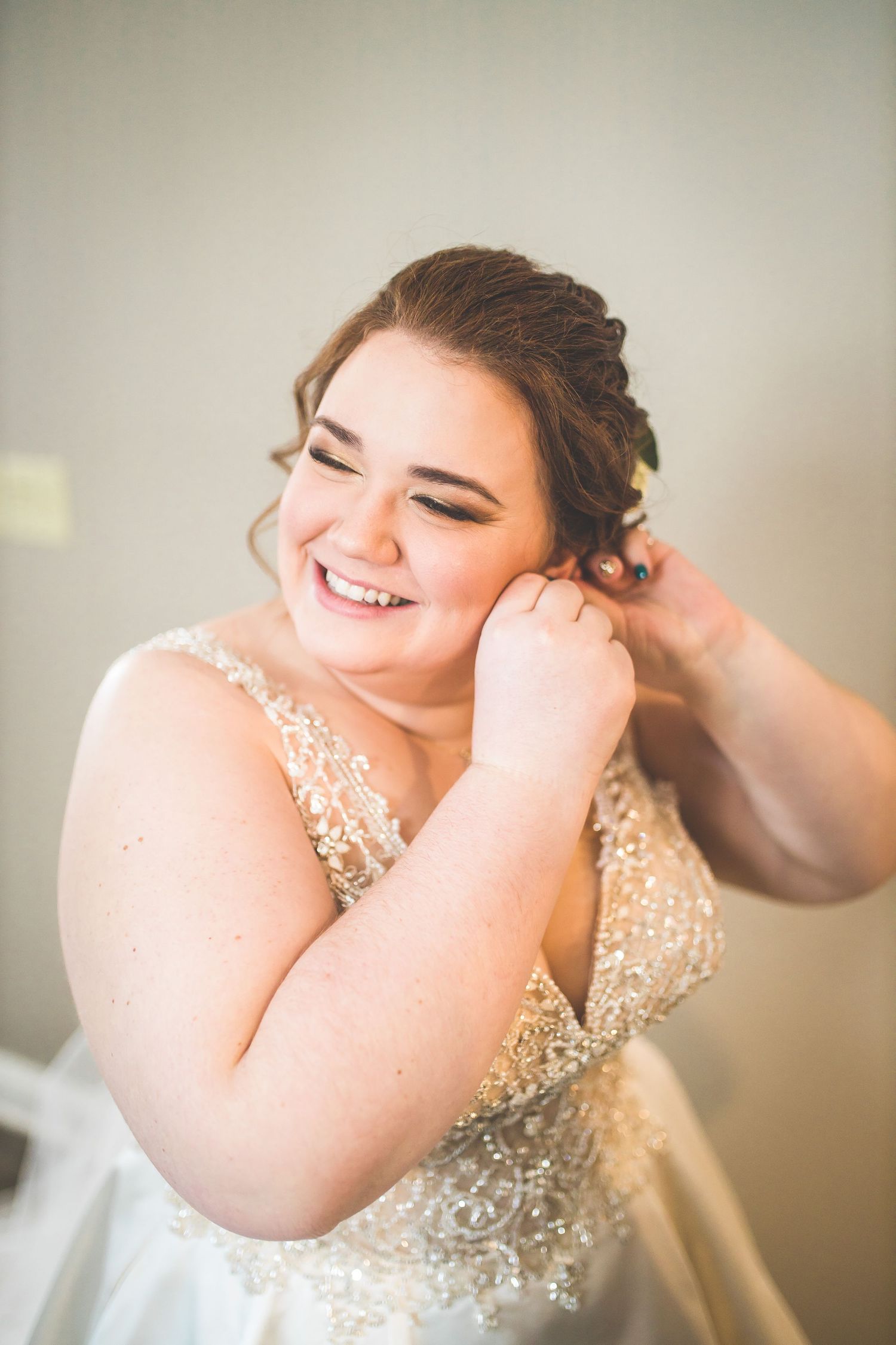 Close-up portrait of a bride wearing a sparkling beaded wedding gown.