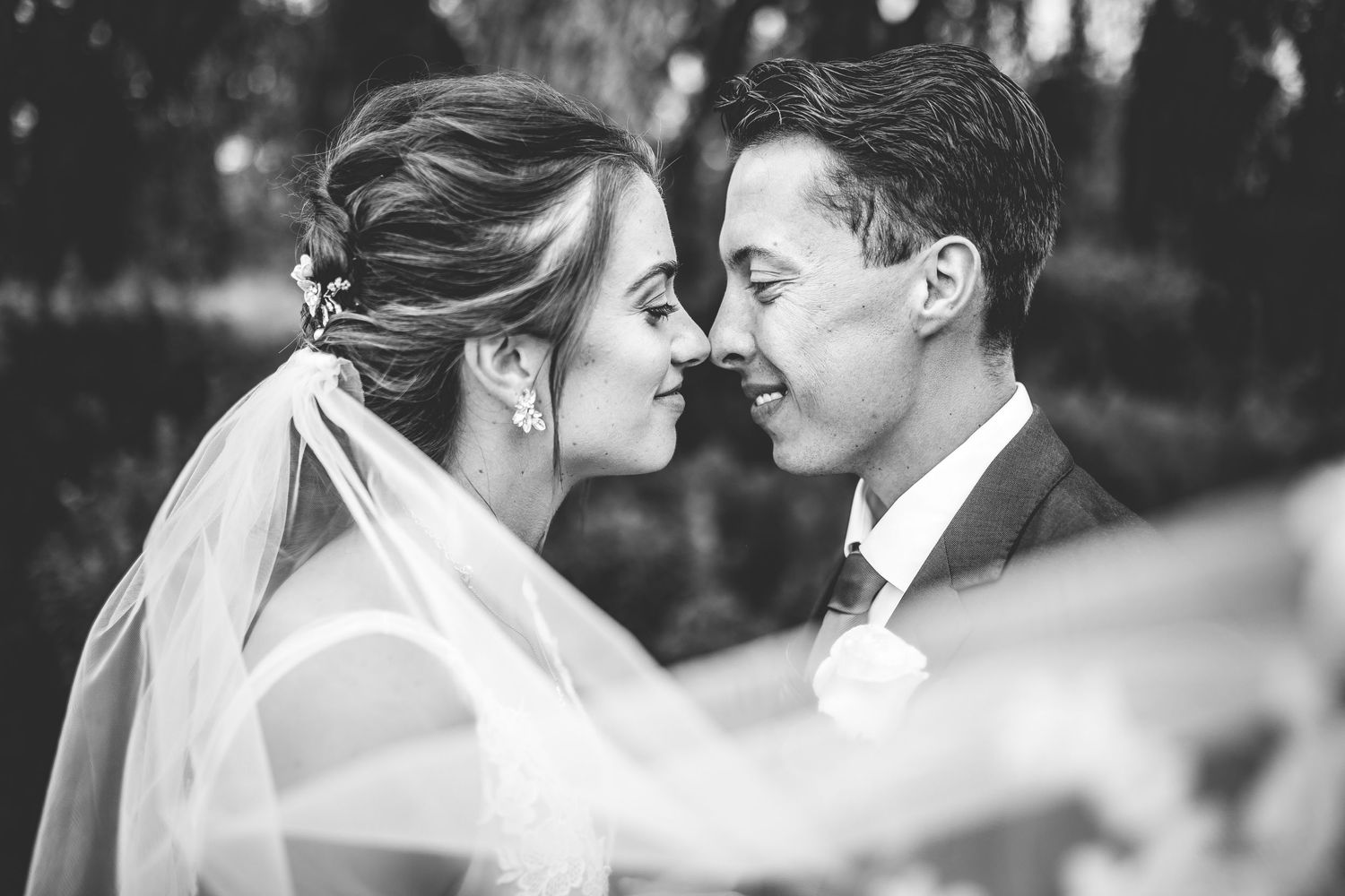Close-up black and white wedding portraits showing intimate moments between the couple.