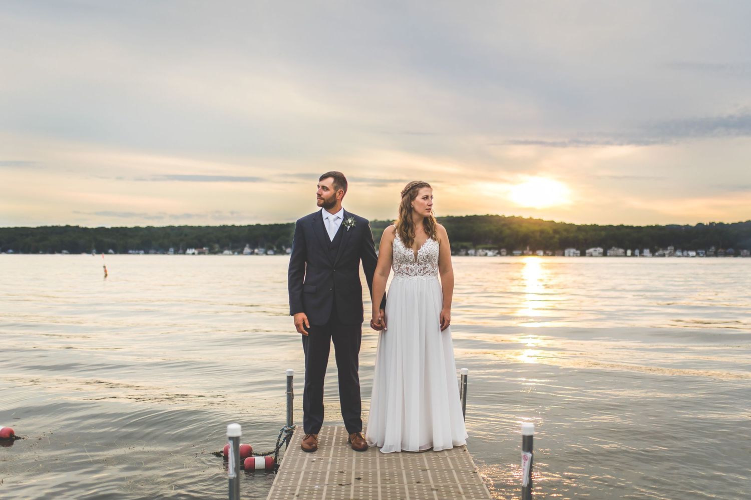 Waterfront wedding photography session at sunset with dock in background.