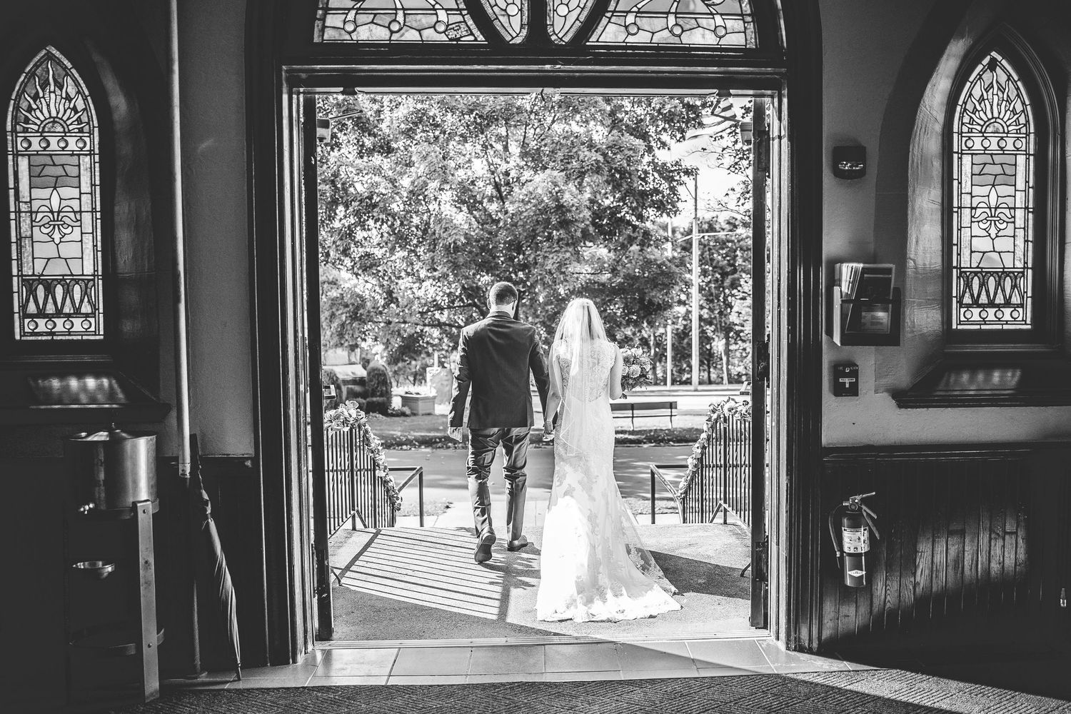 Black and white photos showing church entrance and stained glass windows during a wedding.
