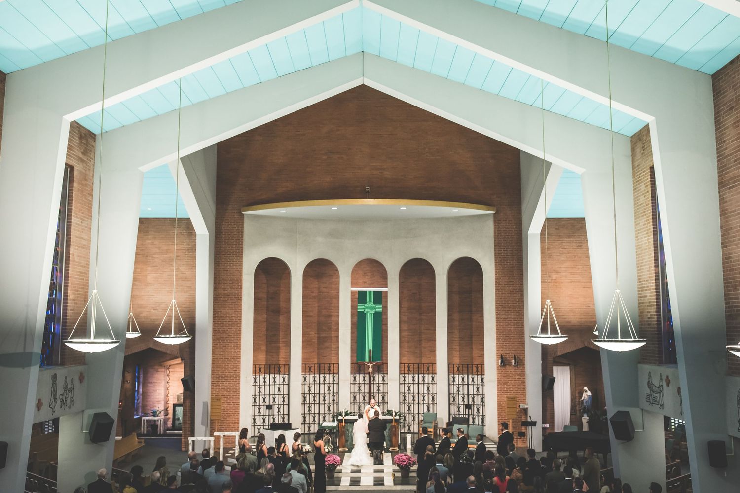 Architectural view of modern church interior with vaulted ceiling and natural lighting.