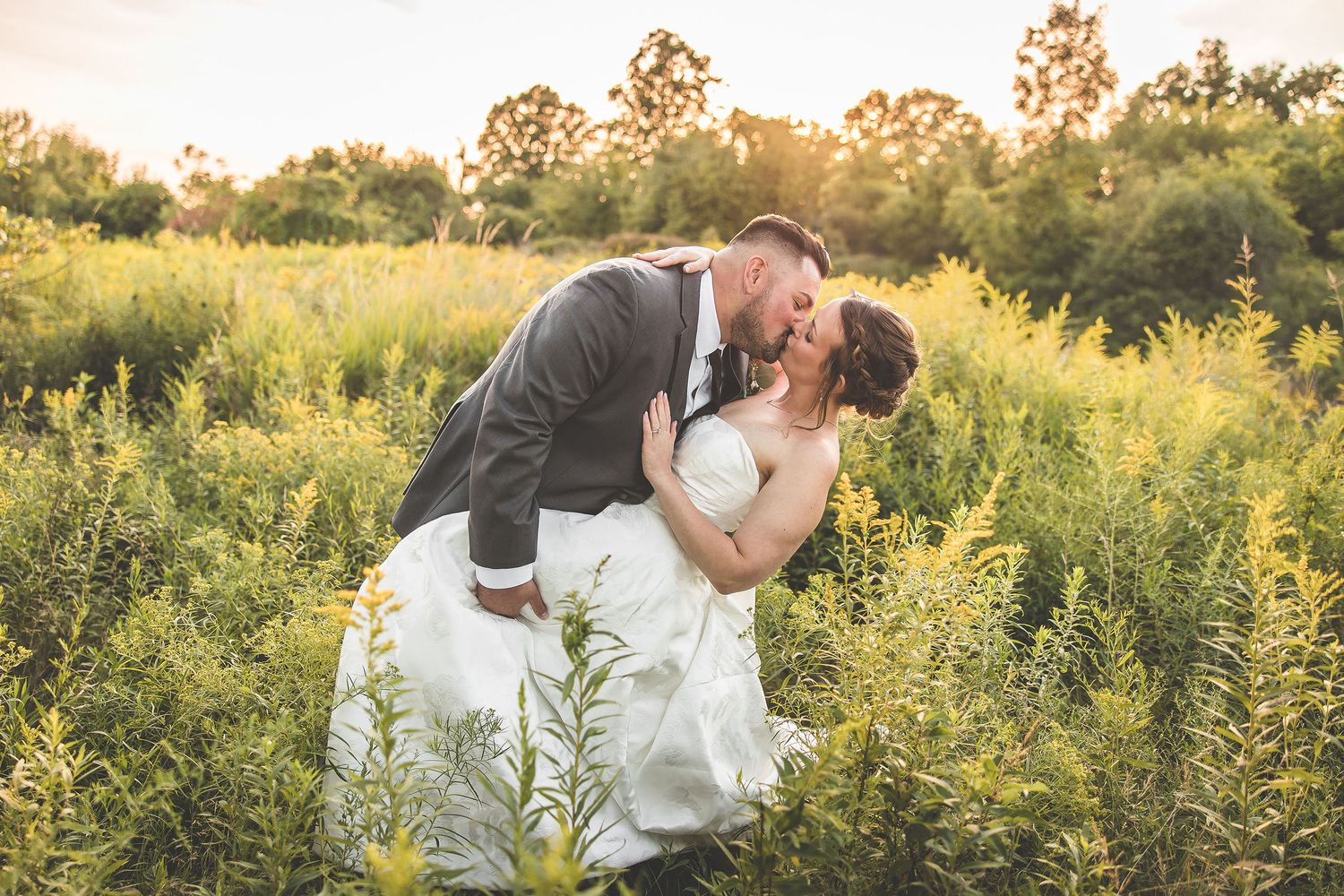 Series of romantic sunset portraits in a wildflower field with golden backlighting.