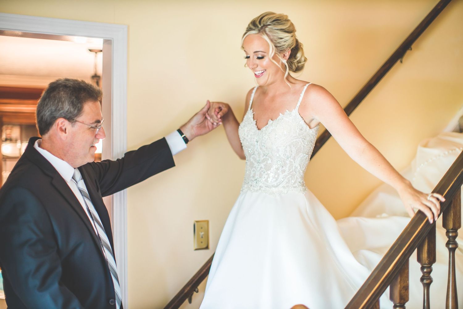 Wedding preparation moments captured on an elegant staircase.