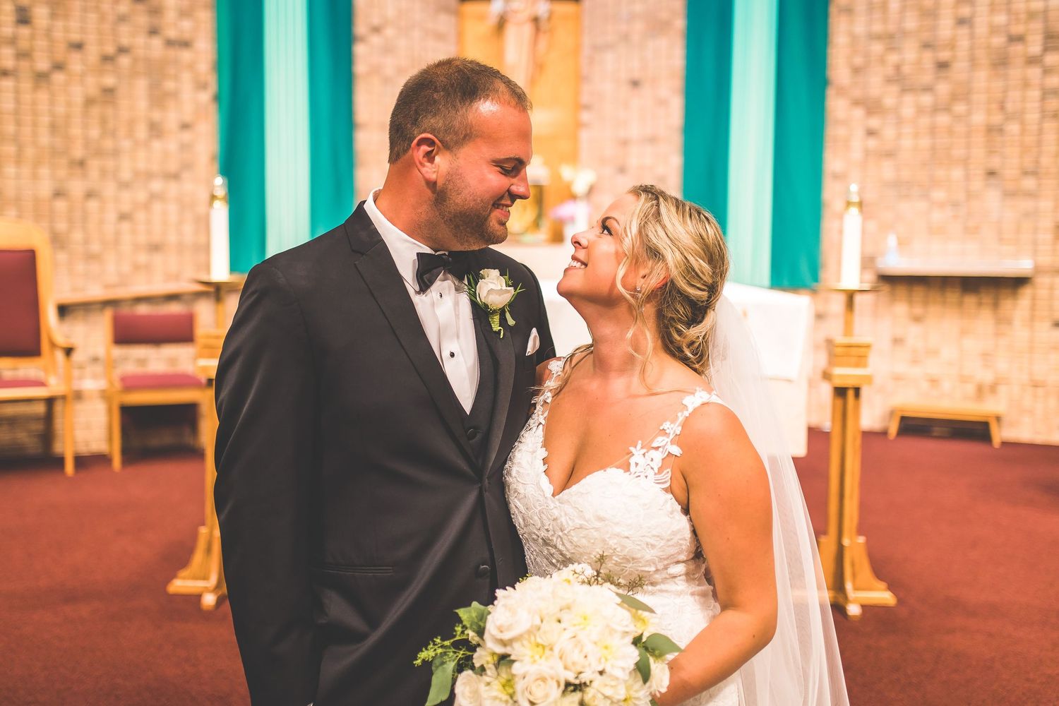 Romantic wedding moments captured against brick church backdrop with turquoise accents.
