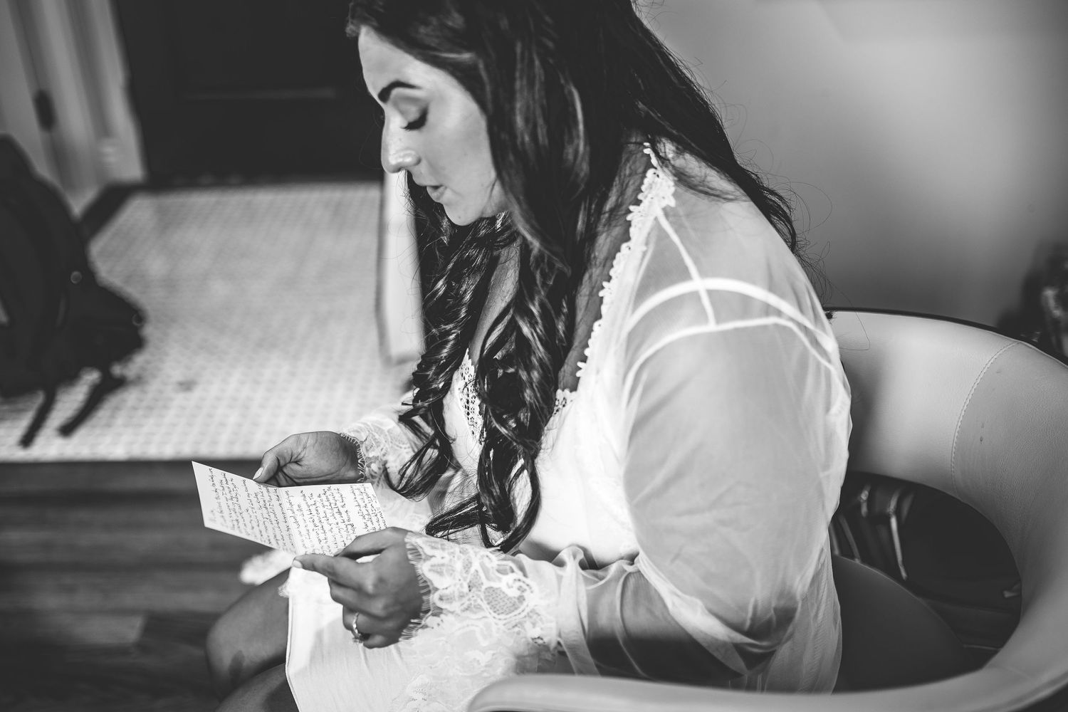 Bride getting ready in elegant white bridal gown and veil.
