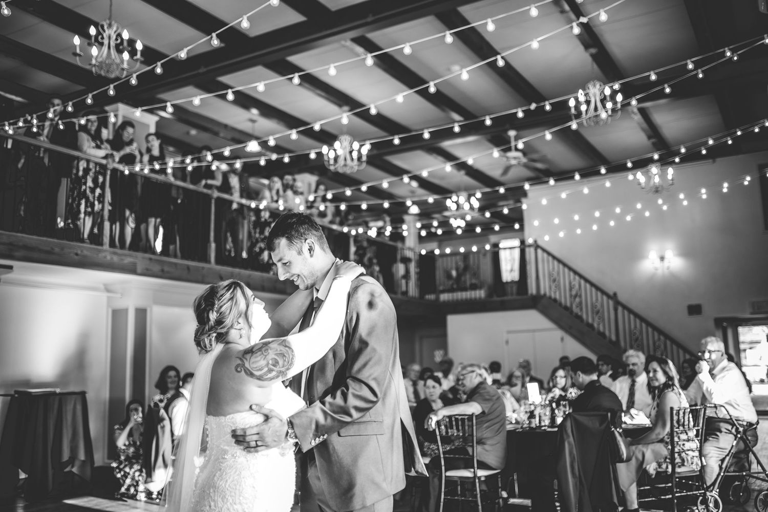 Black and white photos of wedding reception with string lights creating romantic ambiance.