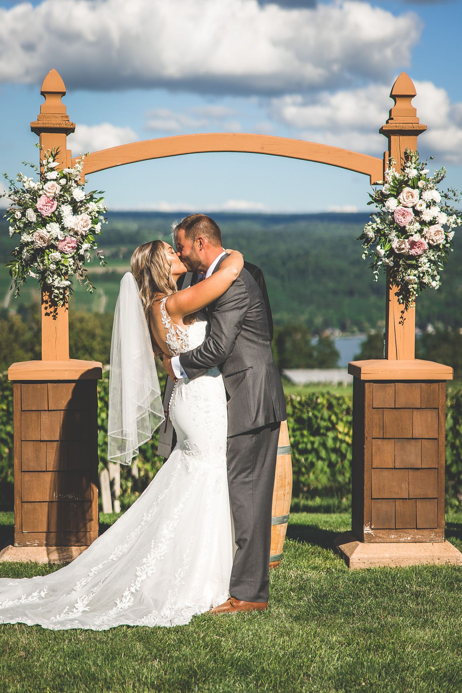 Couple performs choreographed dance moves during their first dance at a scenic vineyard wedding.