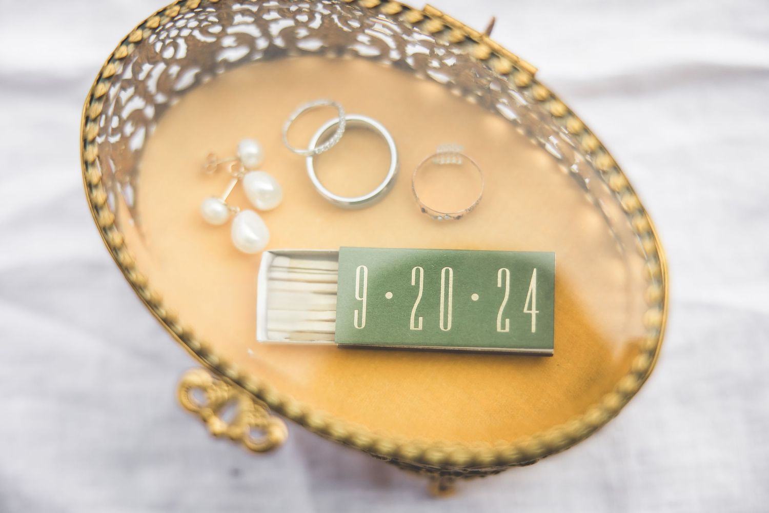 Gold decorative plate with wedding date details and lace accents.