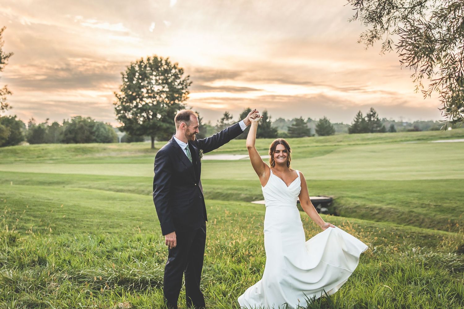Sunset wedding photos on a rolling green golf course landscape.