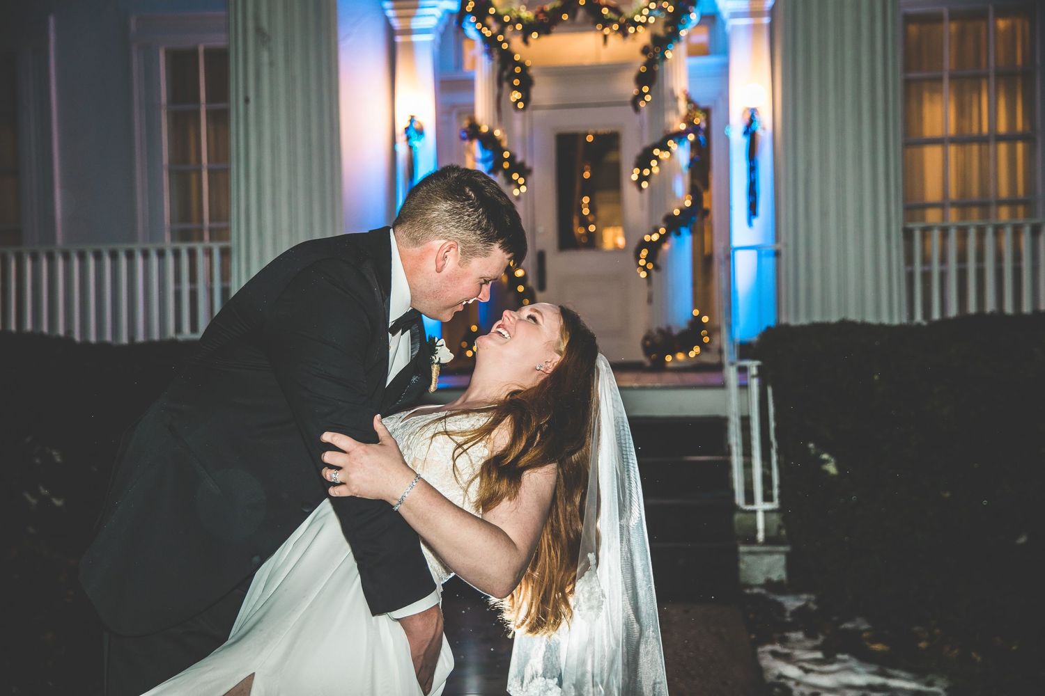 Romantic evening wedding moments captured in an elegantly lit ballroom setting.