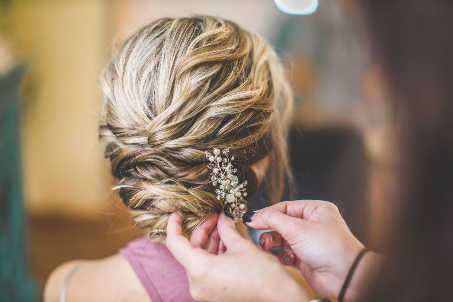 Close-up of an elegant bridal hairstyle with delicate braids and crystal hair accessories.