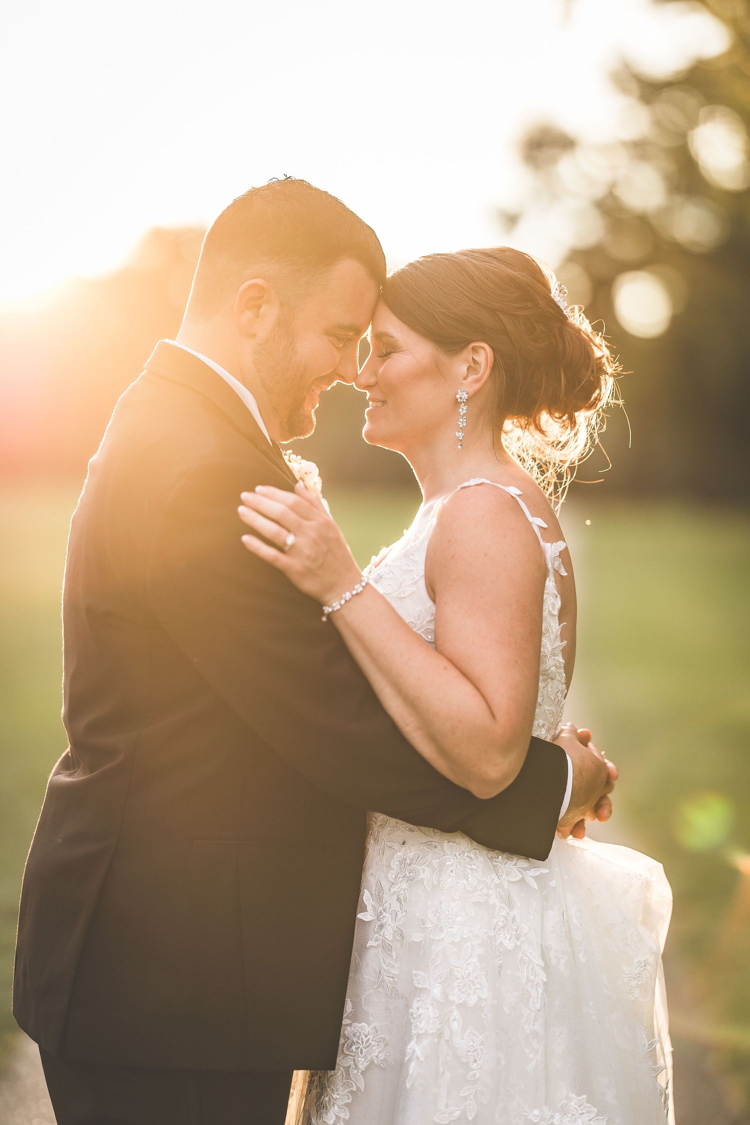 Romantic sunset wedding portraits captured in warm golden light.