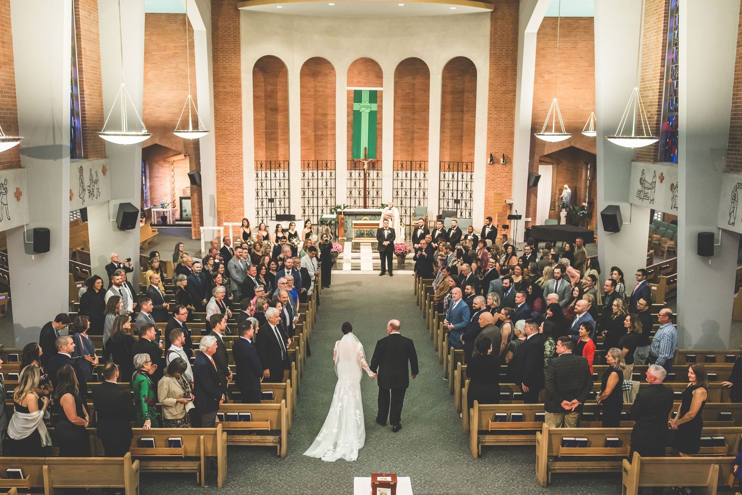 Aerial view of traditional church wedding ceremony with guests filling the pews.