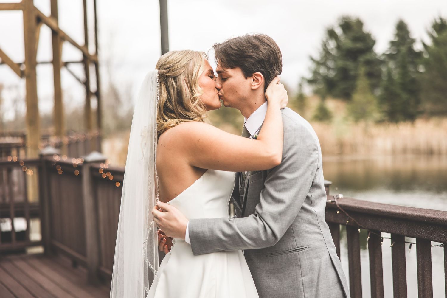 Intimate first look moment between newlyweds on outdoor deck.