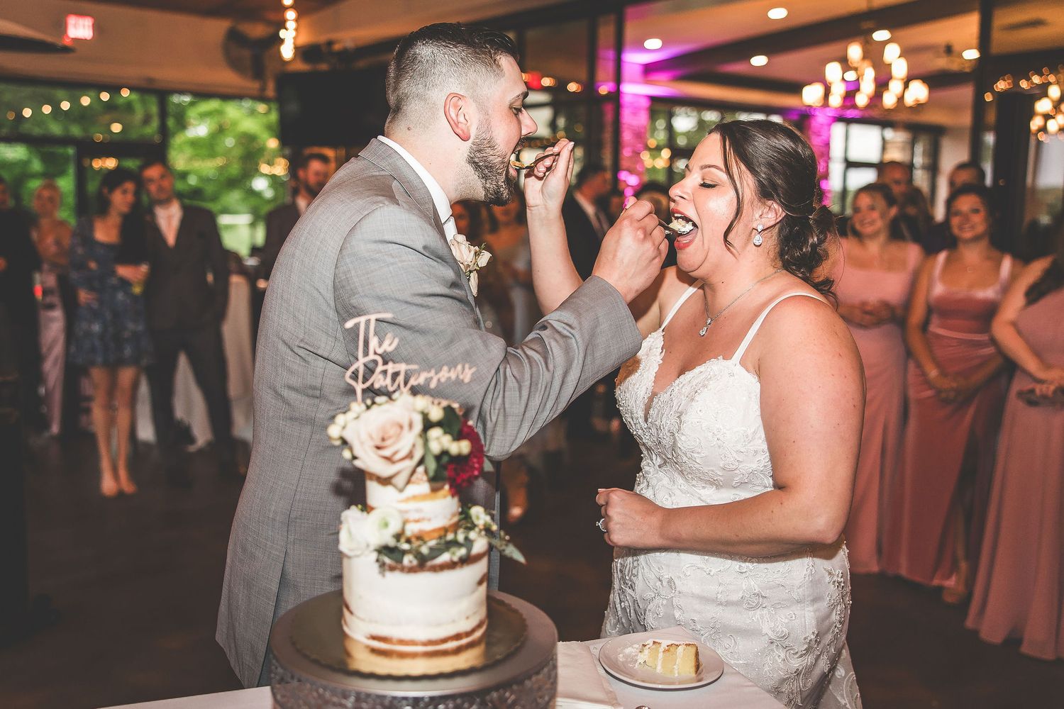 Wedding reception features romantic lighting and elegant cake display.