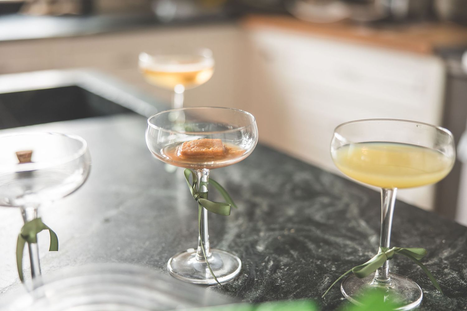 Champagne cocktails arranged on a dark marble surface for wedding celebration.