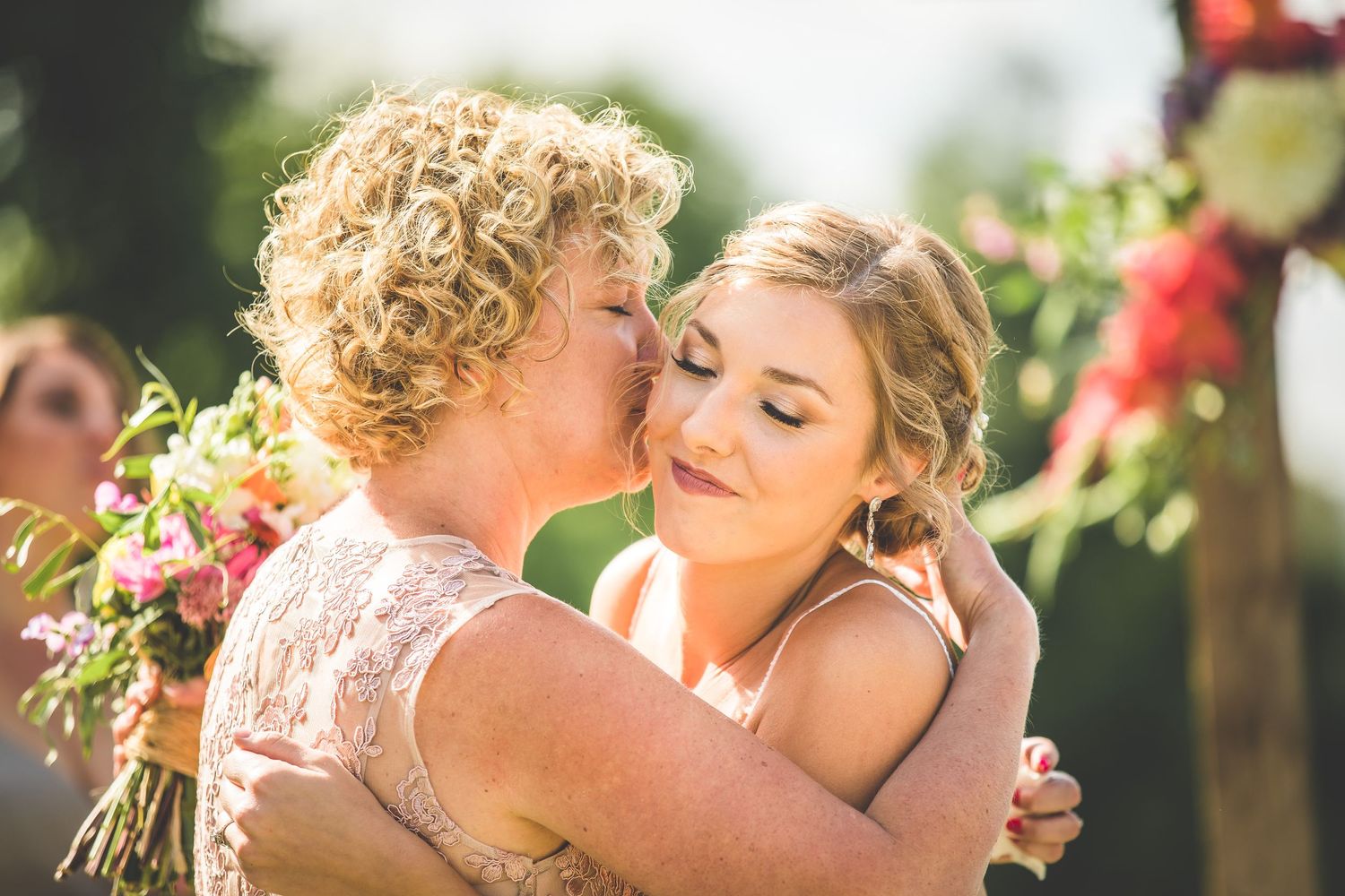 An intimate wedding moment shared between a couple in a garden setting.