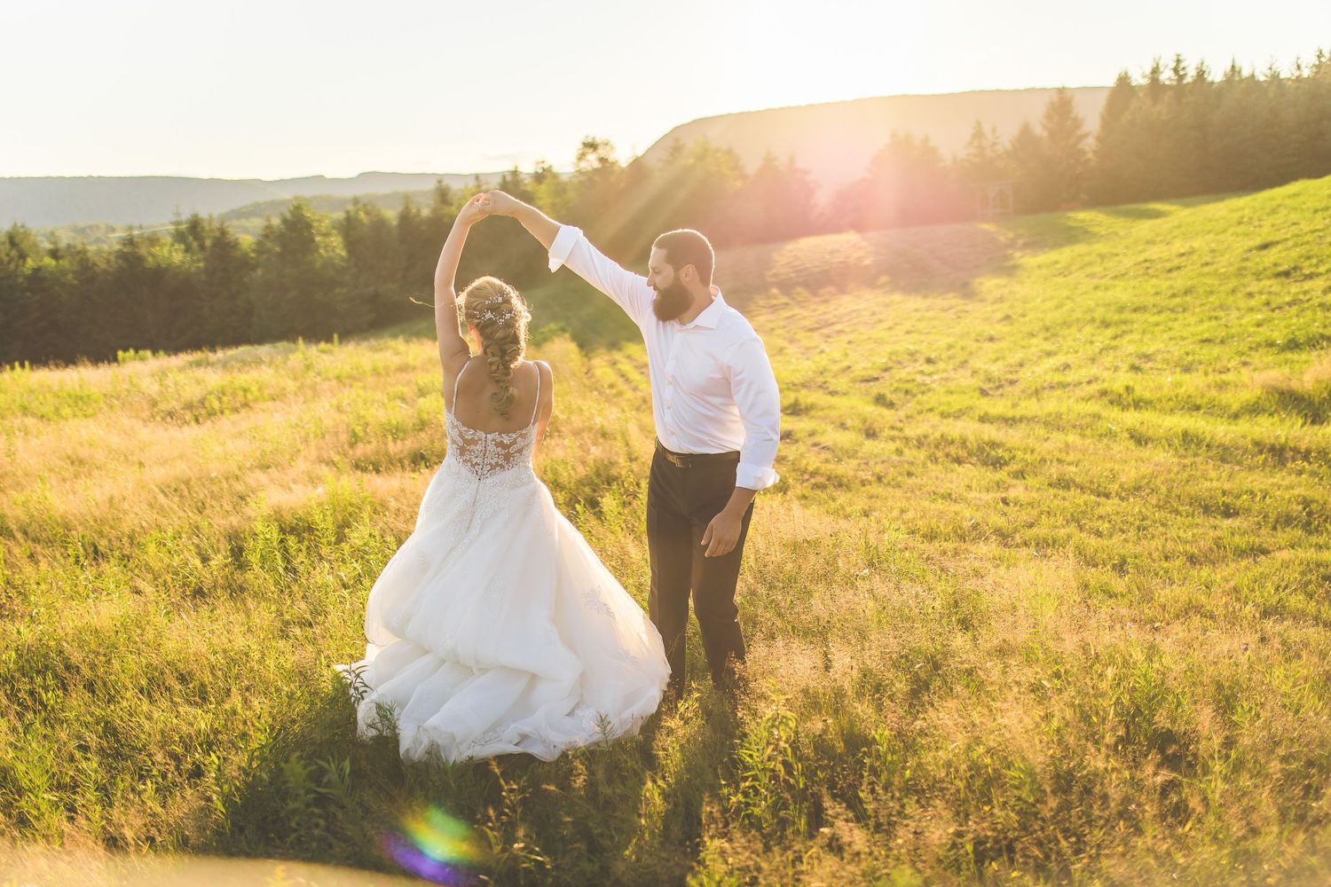 Golden hour wedding photos with stunning mountain landscape backdrop.