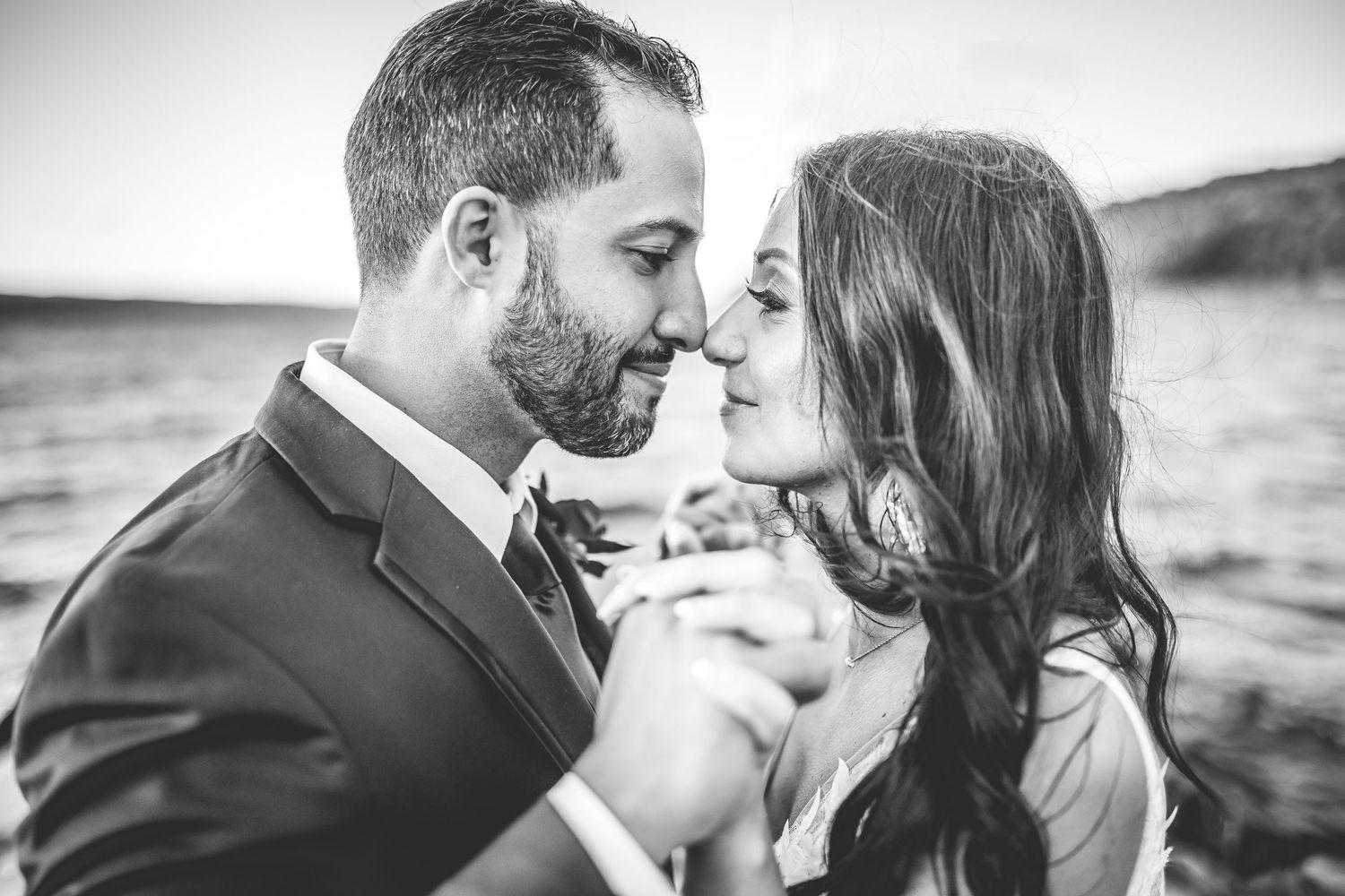 Intimate black and white portrait of couple sharing tender moment.