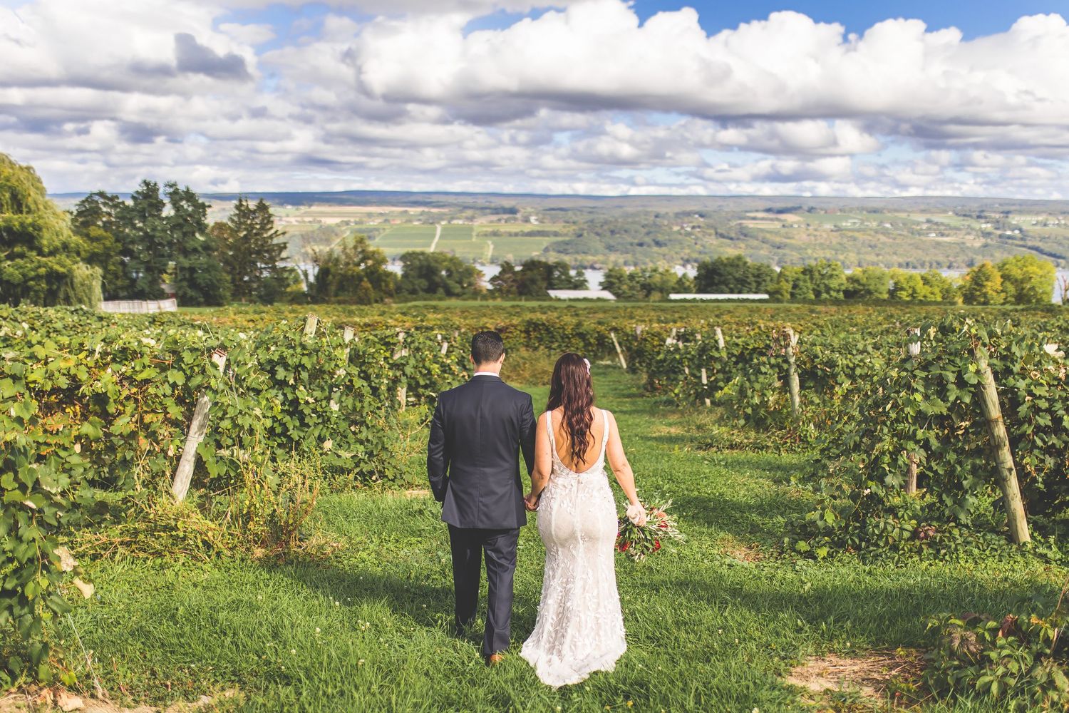 Panoramic view of a vineyard wedding venue with rolling hills in the background.