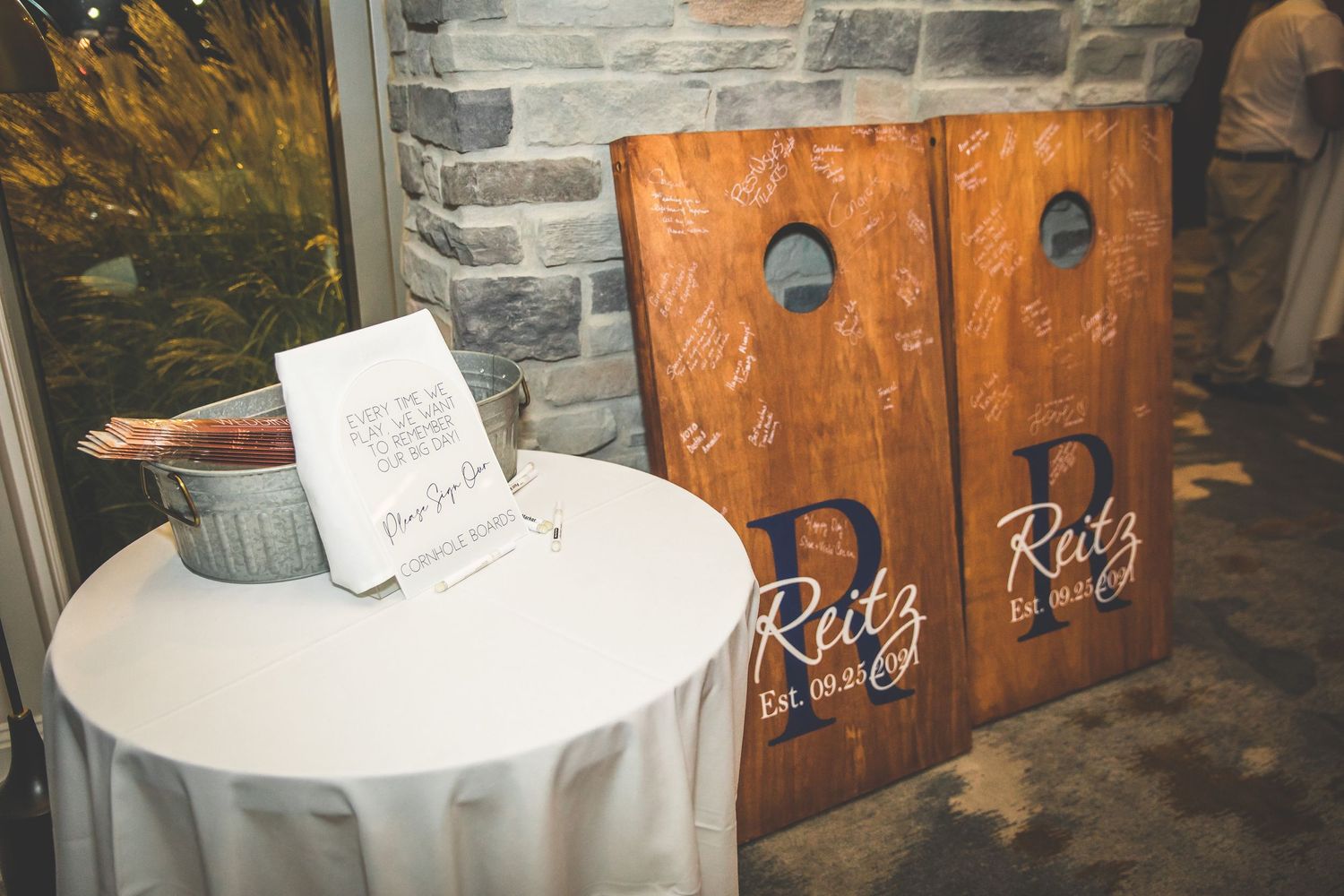 Rustic wooden decor and signage display at wedding reception.