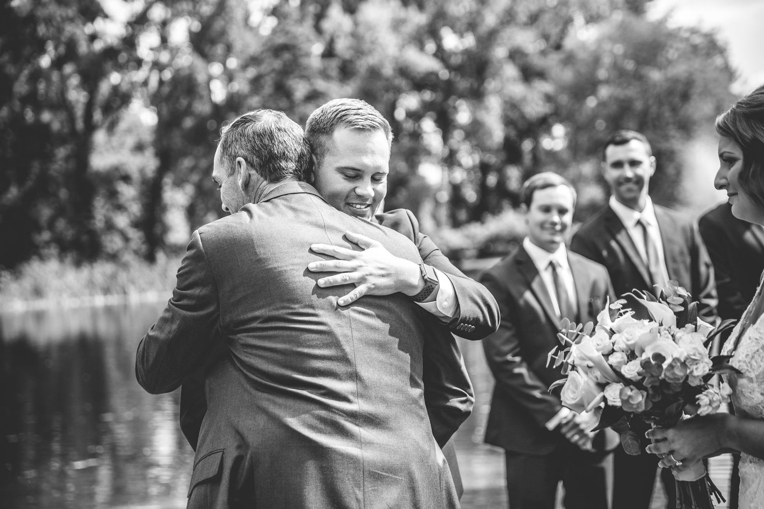 Black and white photos of wedding celebration hugs and embraces outdoors.
