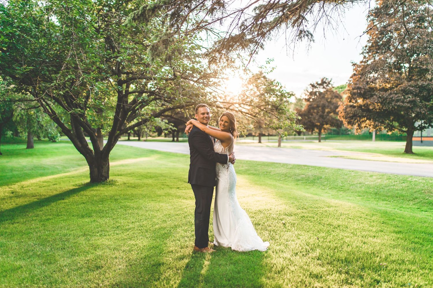 Golden hour wedding portraits taken on scenic golf course grounds.