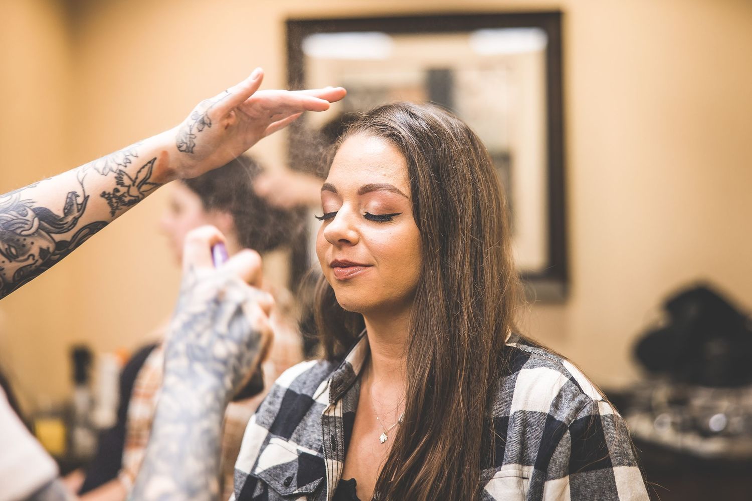 Getting ready scene with hair styling in a casual plaid shirt.