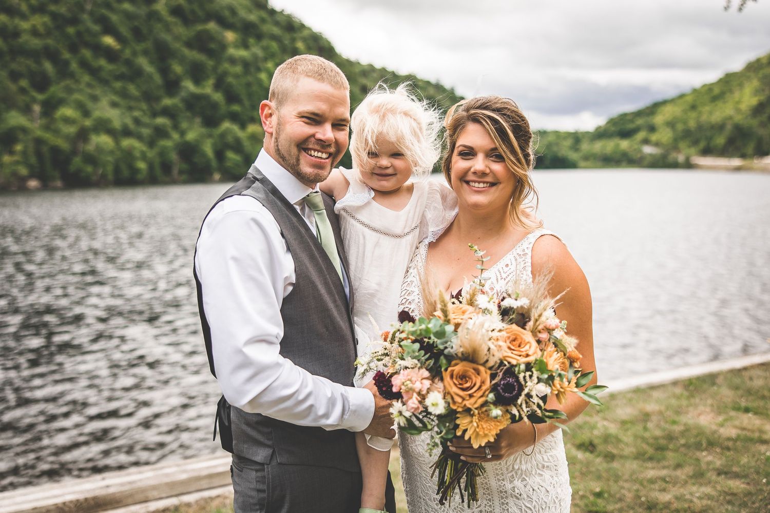 Romantic wedding portraits by a scenic mountain lake.