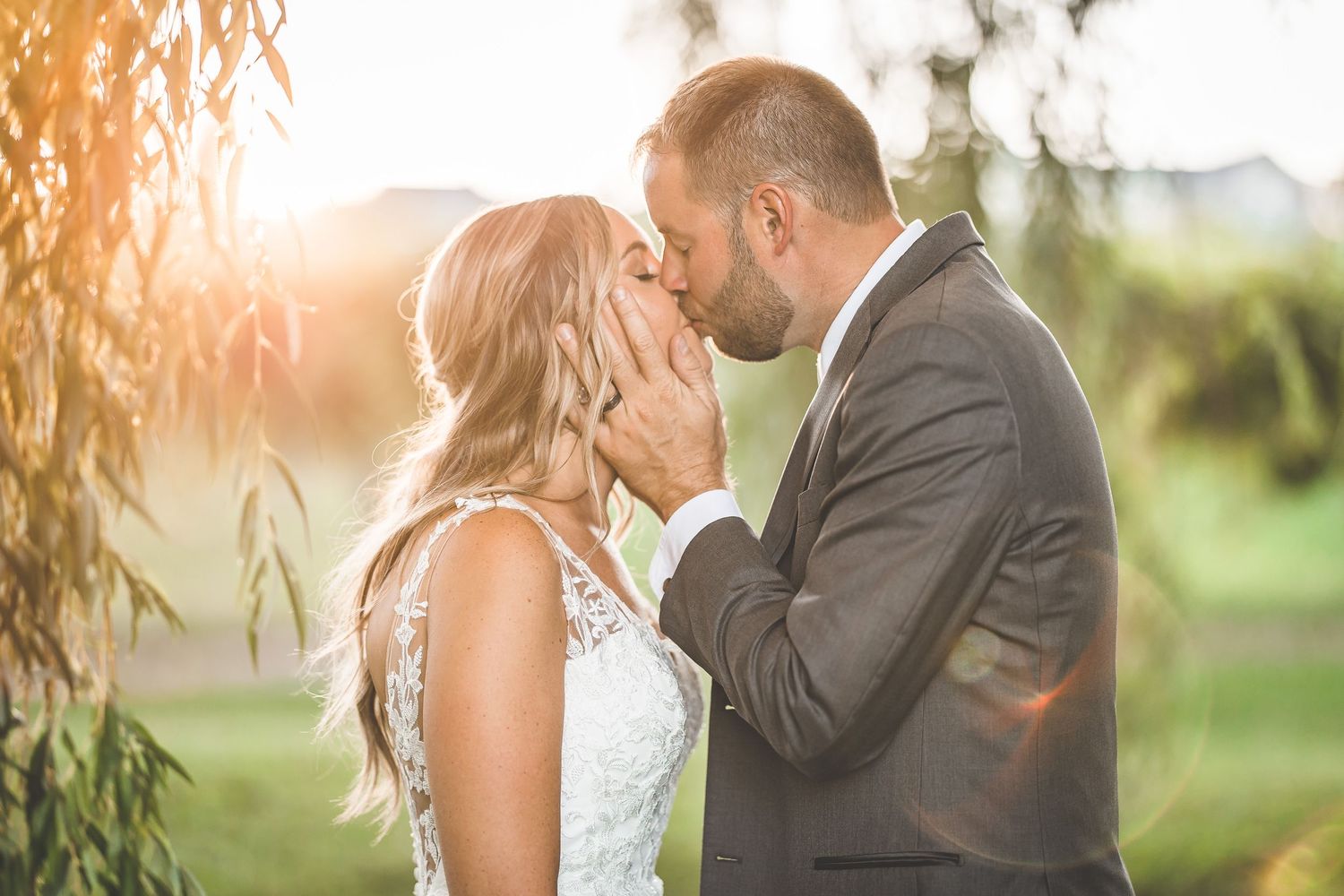 Sunset wedding photography session with warm golden light filtering through trees.