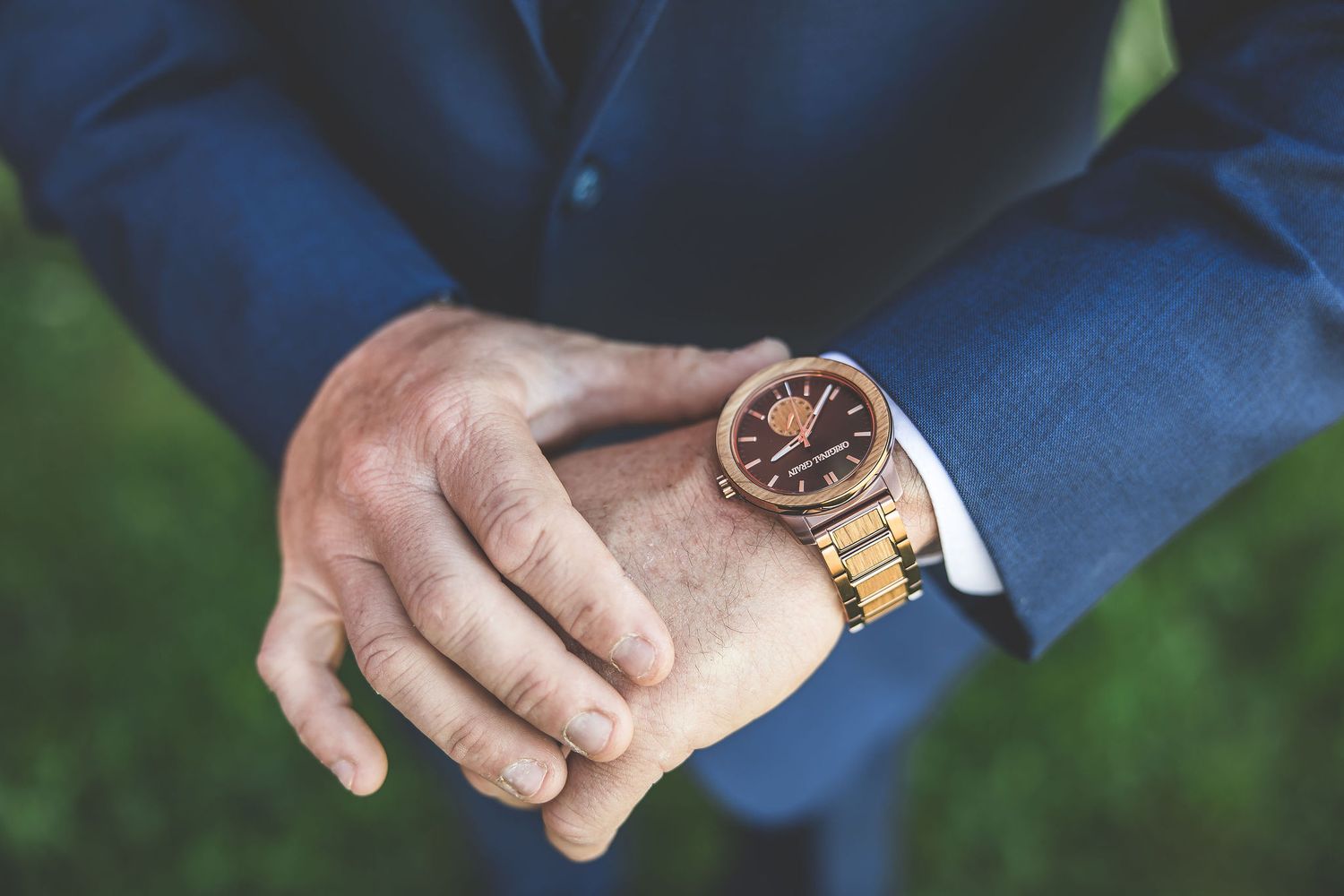 Close-up details of blue suits and accessories worn by wedding party members.