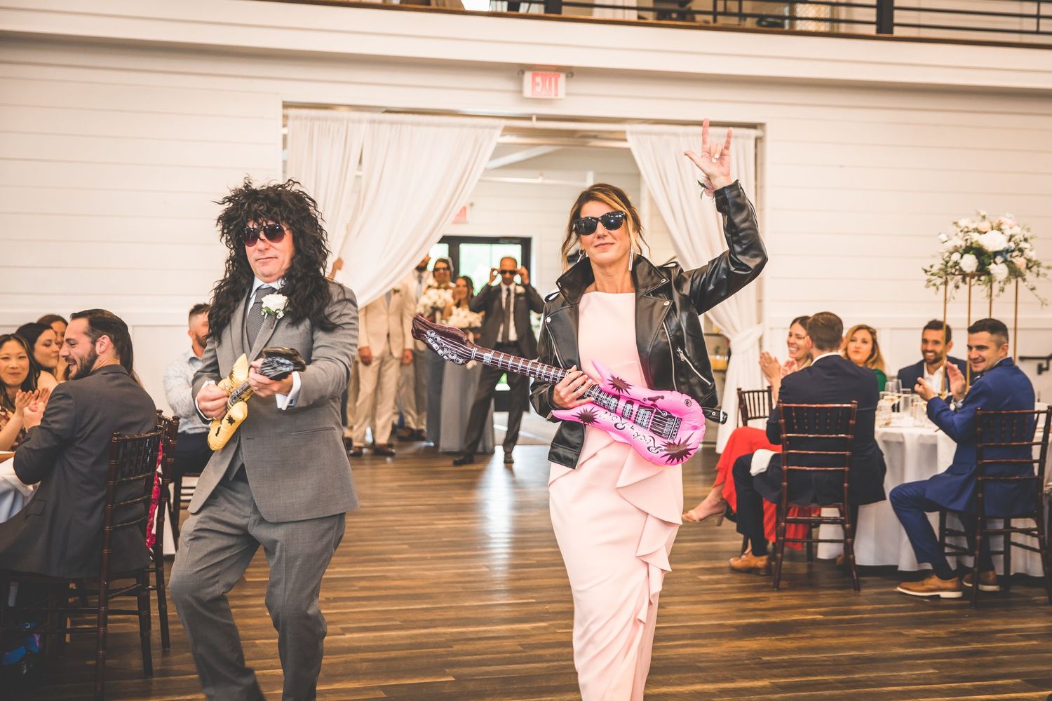 Wedding reception venue interior with guests celebrating on dance floor.