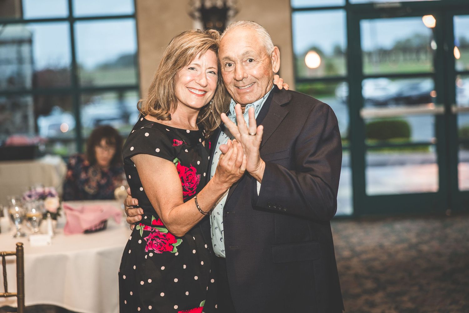Couples enjoying romantic moments during an elegant indoor reception.