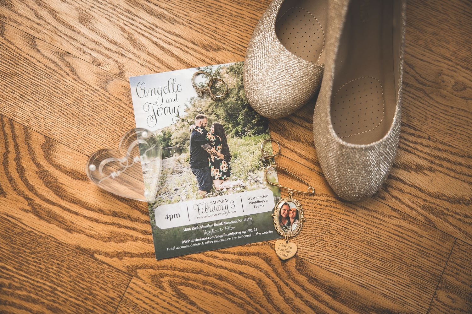 Wedding details including invitation cards and decorative items arranged on a wooden surface.