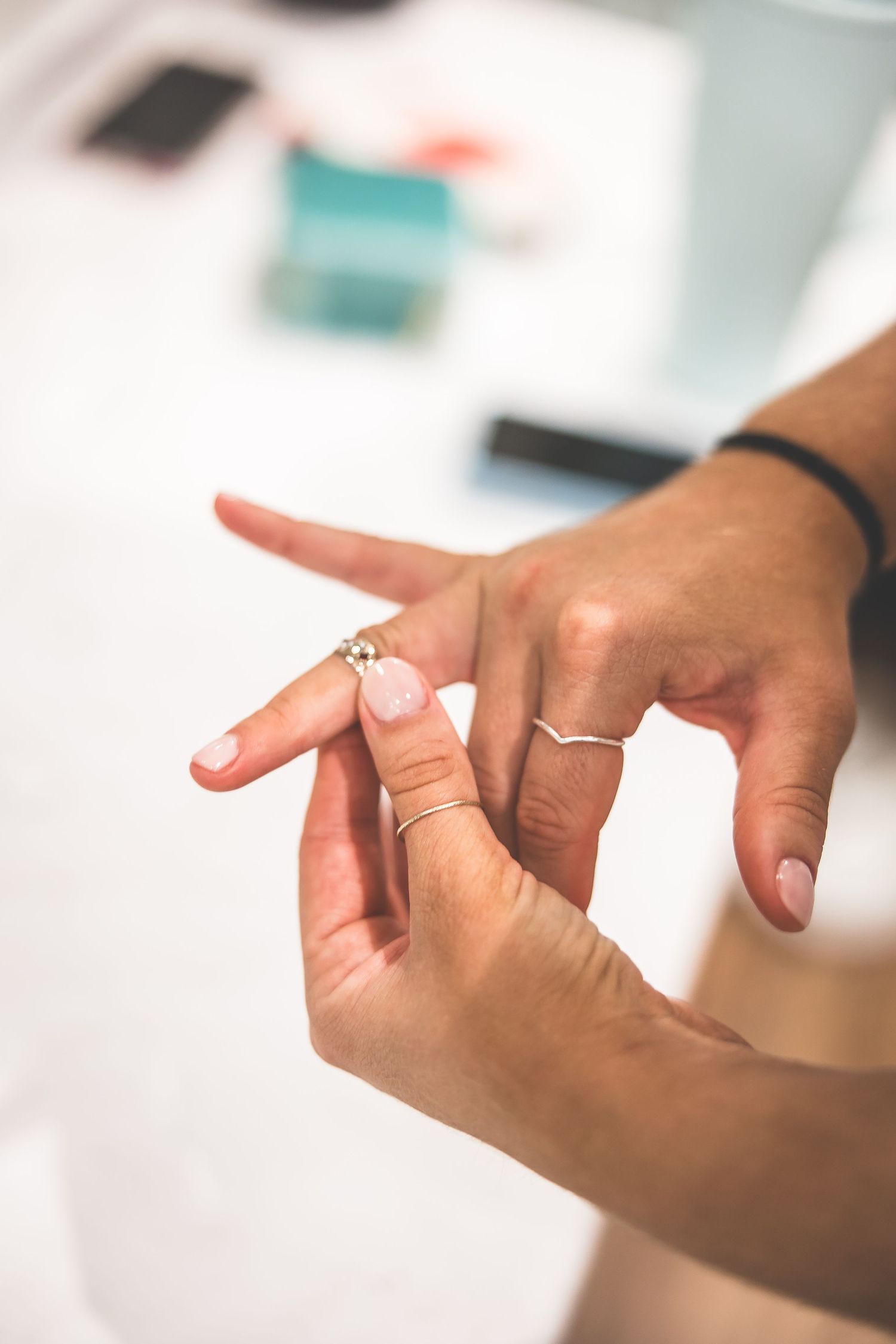 Close-up shot of hands making expressive gestures against a blurred background.
